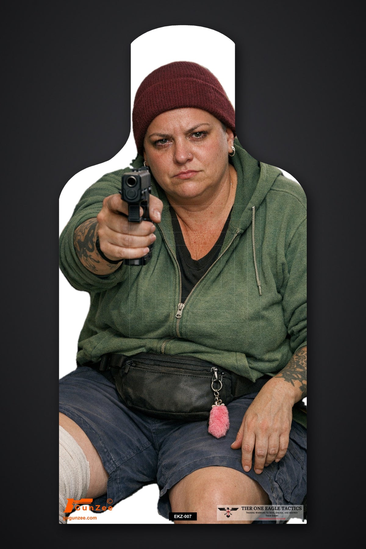 Life-size E-type silhouette target: seated woman in a maroon beanie and green hoodie with a bandaged knee, pointing a pistol with one hand
