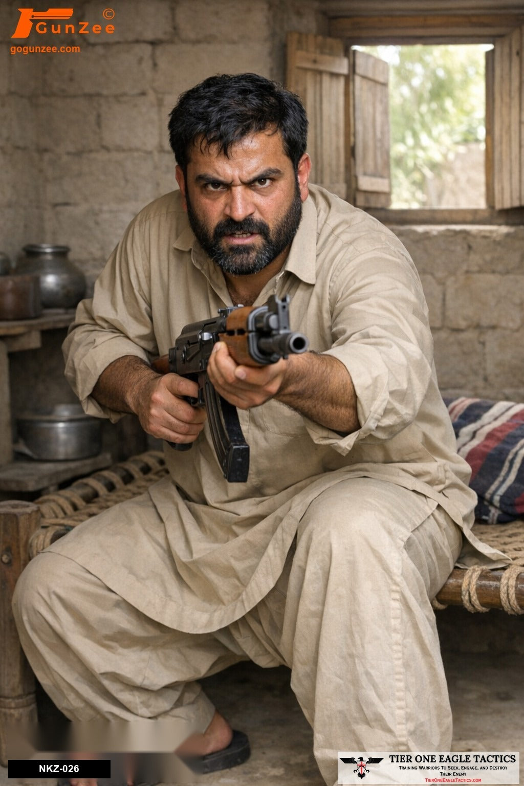 Armed suspect in indoor shelter aiming AK-47 rifle forward, intense expression, wearing beige attire.