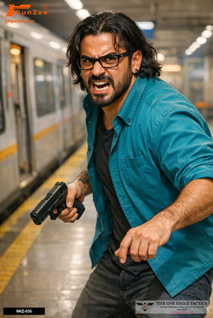 Man in teal shirt with pistol in subway station, aggressive stance