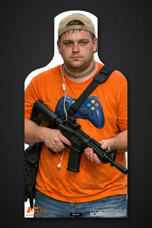 Life-size E-type silhouette target: young man in a backwards cap and orange game-controller t-shirt holding a carbine across his body at low ready