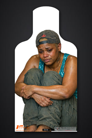 Life-size E-type silhouette no-shoot target: crying woman in a gray cap crouched low with her arms wrapped around her knees